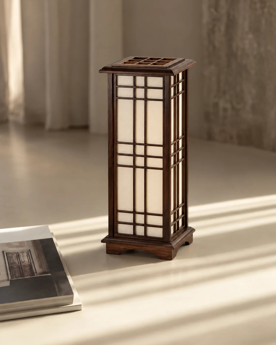 Lampe japonaise Shoji en bois marron posée dans une pièce baignée de soleil